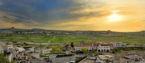 a view of a town with the sunset in the background at Seki Cave Suites in Goreme