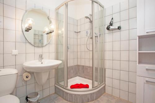 a bathroom with a shower and a sink and a toilet at Haus Ludwigslust in Borkum