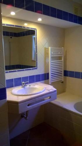 a bathroom with a sink and a mirror at Garden Apartment Quinta do Morgado in Tavira
