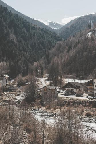 a village in the mountains with snow on the ground at Hotel Residence Giardini in Piode