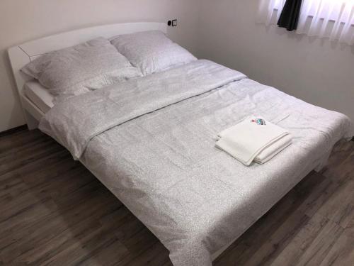 a white bed with white sheets and pillows on it at Motel "KULA" in Cazin