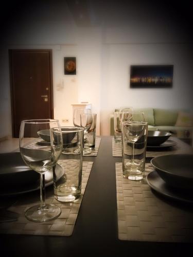 a table with wine glasses and plates on it at EPaN Luxury Apartments in Thessaloniki