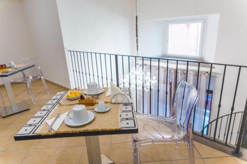 a table and chairs in a room with a balcony at Hotel Rivoli Sorrento in Sorrento