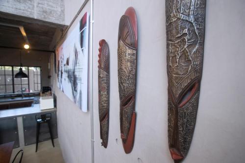 three wooden skis are hanging on a wall at The Cubes in Lusaka