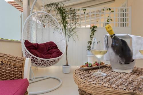 a table with a basket of fruit and a bottle of wine at Artemide Hotel in San Vito lo Capo