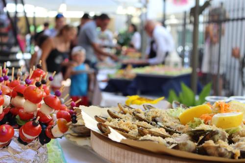 a buffet of food on a table with people at Hotel Astra in Cattolica