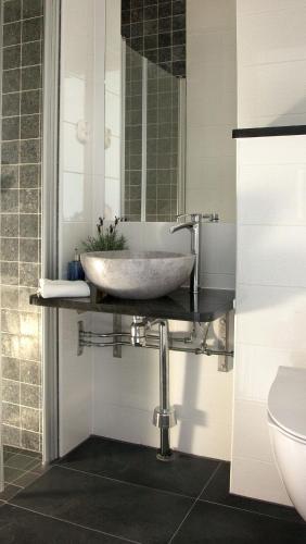a bathroom with a sink and a mirror at Södra Hotellet in Norrköping