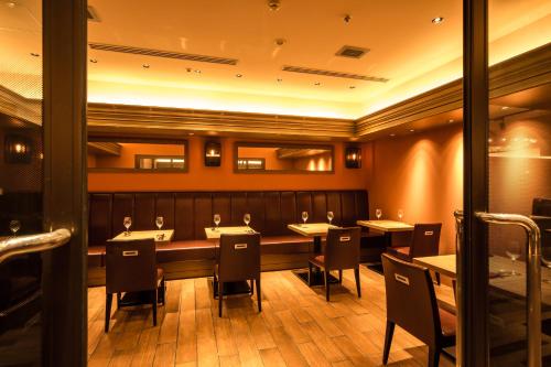a restaurant with a long table and chairs at Osaka Tokyu REI Hotel in Osaka