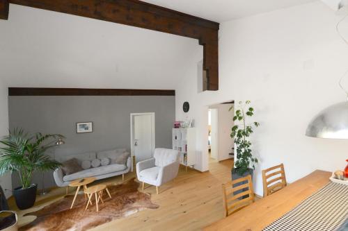 a living room with a couch and a table at Zer Treichi Appartements in Fiesch