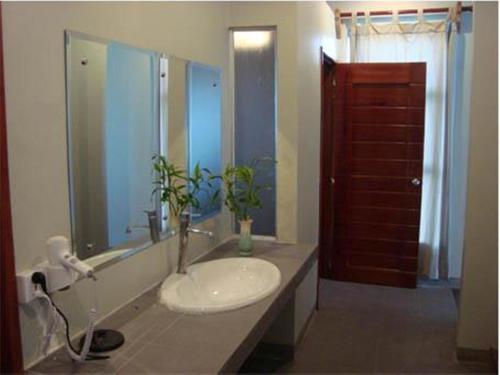 a bathroom with a sink and a mirror at Memoria Palace & Resort in Pailin