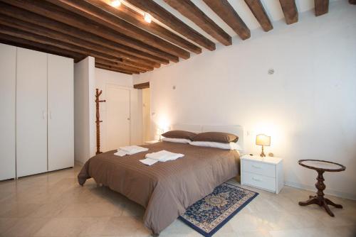 1 dormitorio con 1 cama grande y 1 mesa en La Coccola, en Venecia