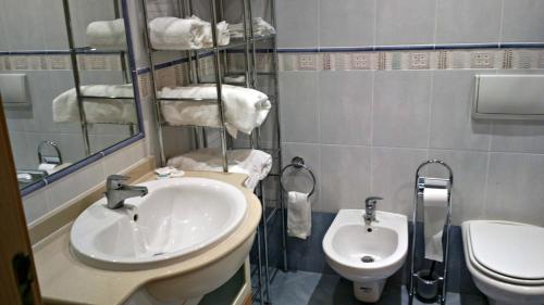 a bathroom with a sink and a toilet at Santa Luzia Dream in Santa Luzia