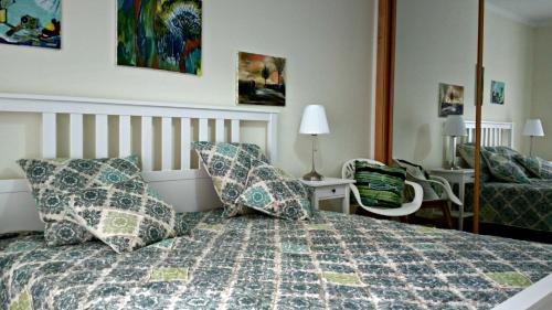 a bedroom with a bed with pillows on it at Santa Luzia Dream in Santa Luzia