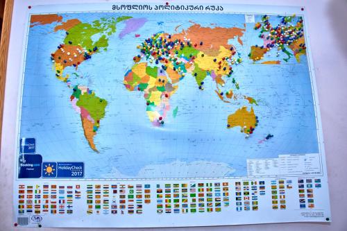 a map of the world on a wall at Nitsa Guest House in Gori