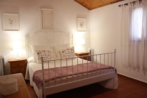 a bedroom with a white bed and a window at La Villa in Mogán