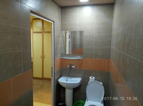 a bathroom with a toilet and a sink at Вили Бийчхаус in Kranevo