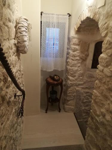 a stone hallway with a table and a window at Il viandante in Sulmona