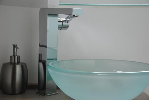 a bathroom with a sink and a glass bowl at Glück Auf im Pott in Bottrop