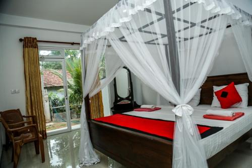 Ένα ή περισσότερα κρεβάτια σε δωμάτιο στο One-plus Holiday Homes Mirissa