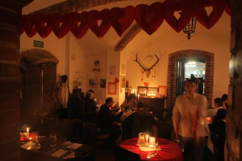a group of people sitting at tables in a restaurant at Zamek Reszel in Reszel