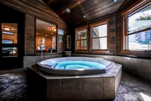 a jacuzzi tub in a room with windows at The Lodge at Steamboat by Vacasa in Steamboat Springs