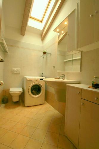 a bathroom with a washing machine and a sink at Il Castello in Pergine Valsugana