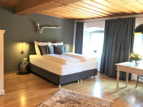 ein Schlafzimmer mit einem großen Bett und einer Holzdecke in der Unterkunft Apartments Mauritiushof Weingut FJ Gritsch in Spitz