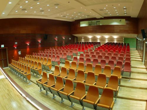 an empty auditorium with red seats in a theatre at Regiohotel Manfredi in Manfredonia