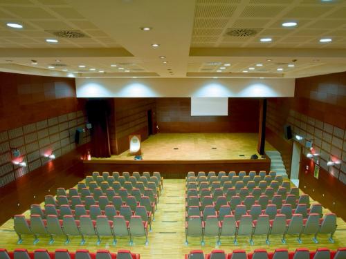 an auditorium with rows of chairs and a stage at Regiohotel Manfredi in Manfredonia