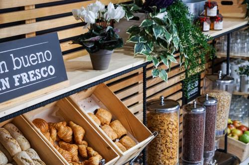 a bakery with breads and other foods on a shelf at Ibis Girona in Girona