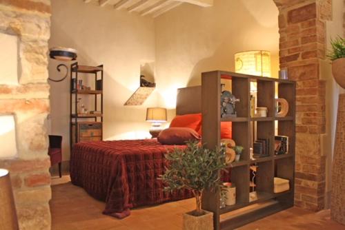 a bedroom with a bed and a book shelf at Il Rifugio dell' Artista in Todi