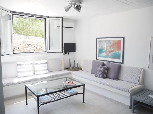 a living room with a couch and a table at Kea Villa Thea- Villa Ilios in Vourkarion