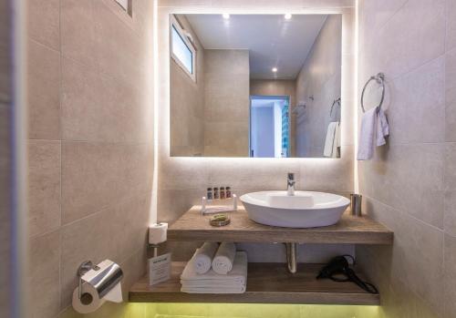 a bathroom with a sink and a mirror at Acropolis Stay in Athens