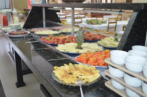 a buffet line with many different types of food at Presidente Hotel in Poços de Caldas