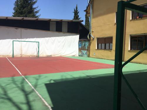 a tennis court in front of a building at Hotel Rural Camino Medulas in Ponferrada