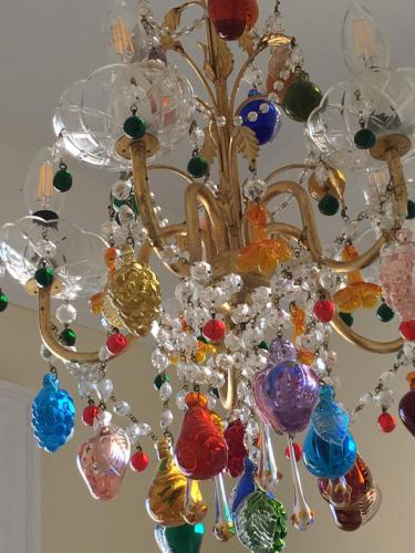 a chandelier with many glass ornaments on it at The Queen Hotel in Olney