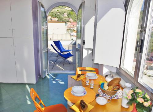 a dining room with a table and chairs and a balcony at Terrazza Bello in Portovenere