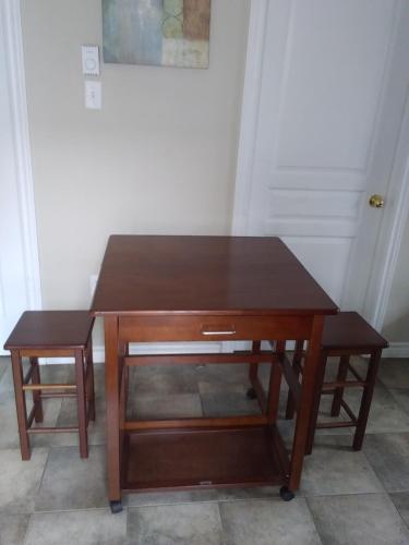 a wooden table with a drawer in a room at Rothesay Motel in Rothesay