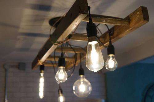 a cluster of lights hanging from a ceiling at Y Gorsaf in Llanfairpwllgwyngyll