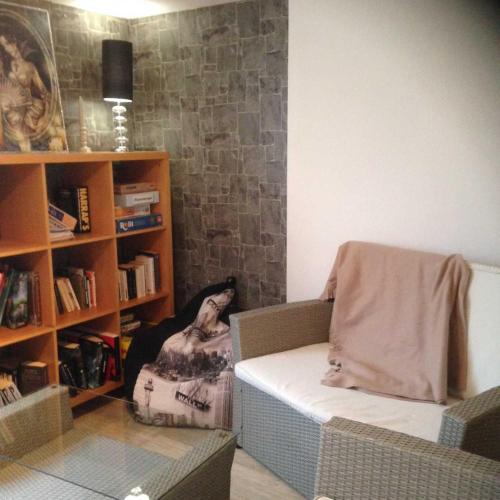 a living room with a couch and a book shelf at Chambre d'Hôtes Hola in Laval