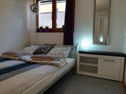 a bedroom with a bed with a dresser and a mirror at U Siebie w Gorach II in Bukowina Tatrzańska