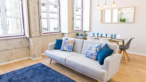 a living room with a couch and a table at Praça 44 in Braga