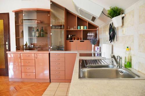 a large kitchen with a sink and a counter at Apartman EXCLUZIV in Prijedor