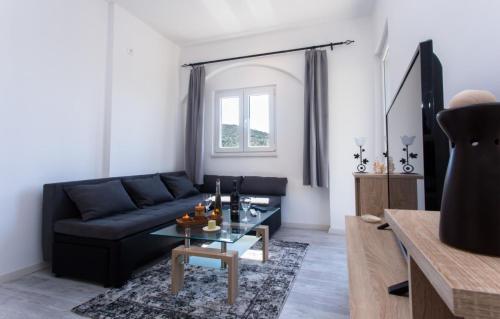 a living room with a black couch and a glass table at Joseph - superior sea bay and mountain view in Cavtat