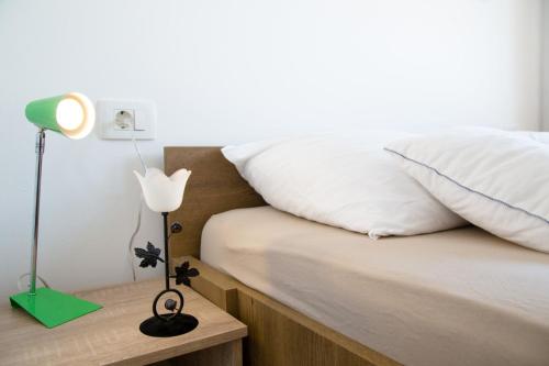a bedroom with a bed and a lamp on a night stand at Joseph - superior sea bay and mountain view in Cavtat