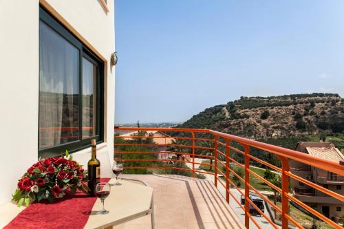 a balcony with a table and glasses of wine at Estate Kares in Tílisos