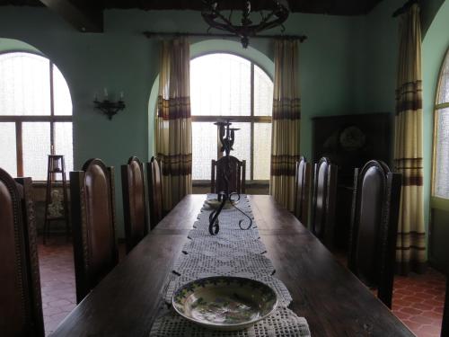 a dining room with a table with a camera on it at Casa São João in São João da Serra