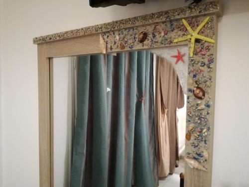 a door with a curtain in a room at Fantastic View Studios Kythnos in Kithnos