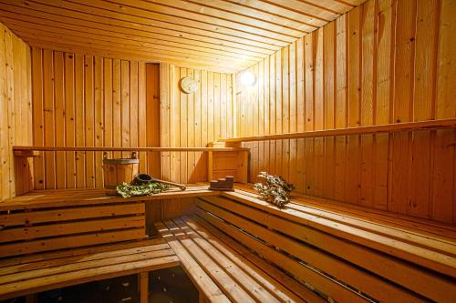 a large wooden sauna with a bench in it at Guest House Dzhangal in Bansko