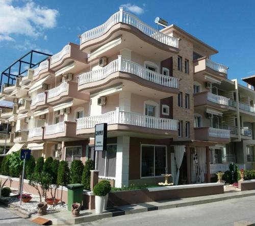 a large apartment building with balconies on a street at Epavlis Luxury apts in Leptokaria
